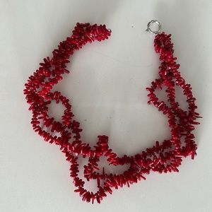 Red beaded necklace (sits around collarbone)